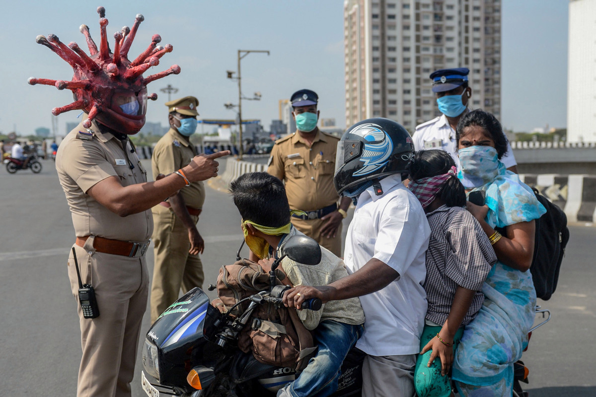 Cops wear coronavirus helmets to scare residents into lockdown in India 1