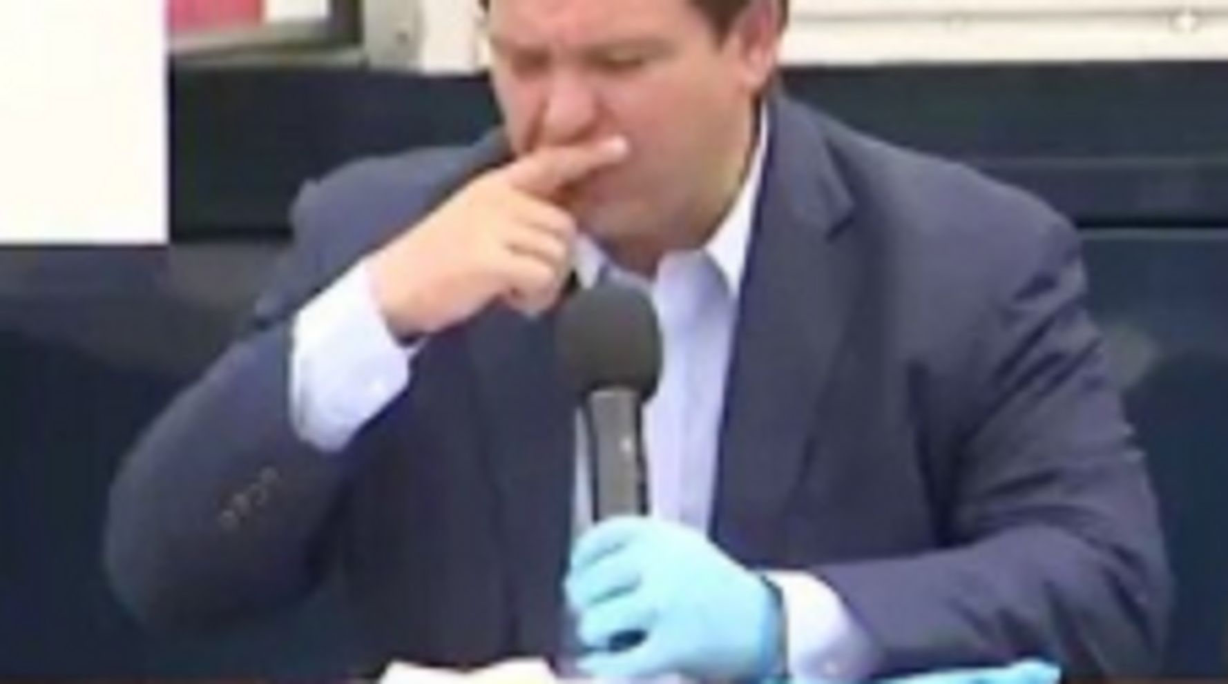 Florida Gov. Mystified By Gloves And How To Wear Them During Coronavirus Briefing 1