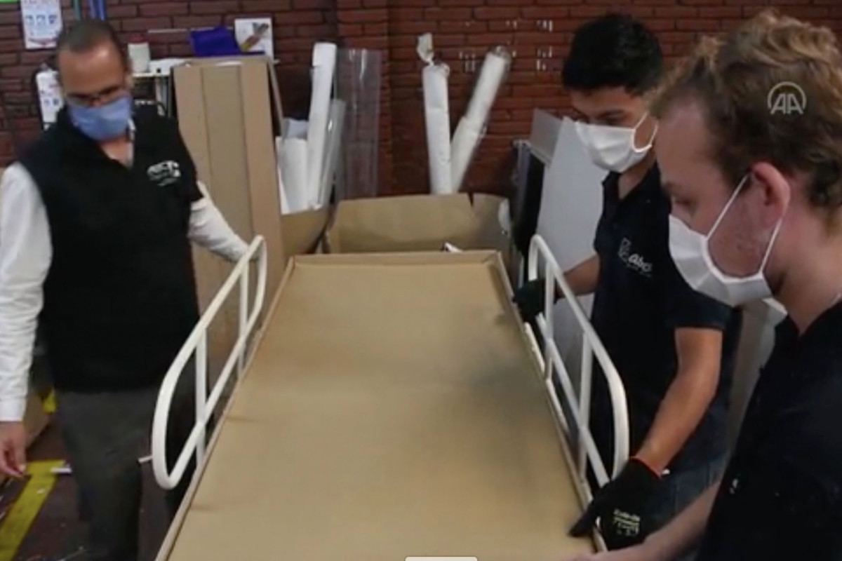 Factory makes coronavirus hospital beds that can be turned
into coffins 1