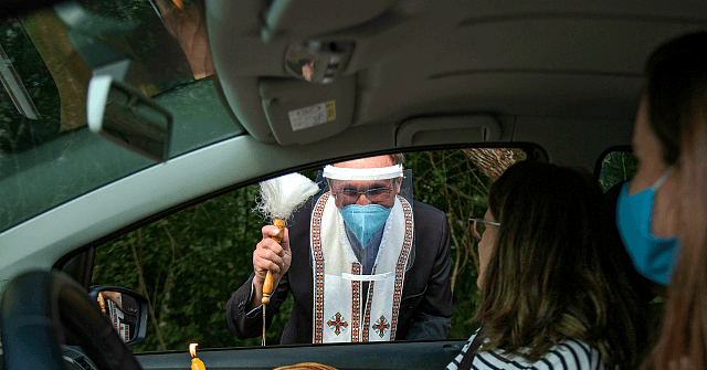 Coronavirus: Ukrainian Priests Tend to Sick in Biohazard
Suits 1
