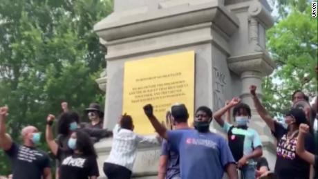Protesters in Raleigh replace the inscription on a
Confederate monument with a memorial for George Floyd 1