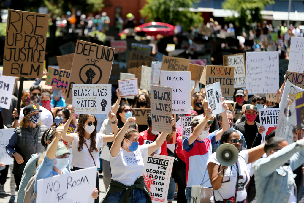 Protesters call for end to systemic racism in policing,
housing, education and more 1