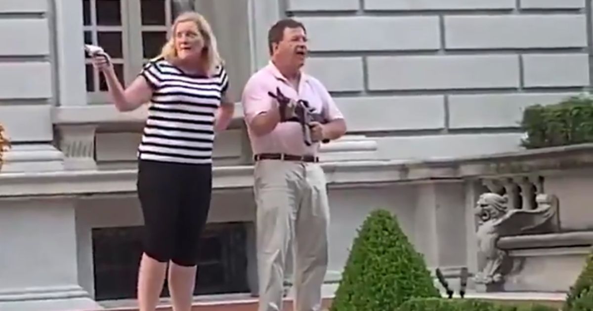 Protesters Bust Through Gate into Private Community, Meet
Armed Couple Standing Guard at Home 1