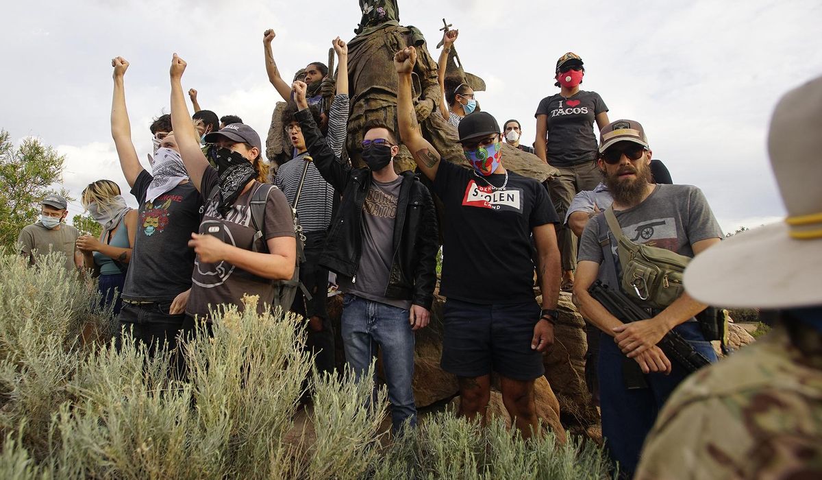 Protester shot during confrontation over removing statute in
New Mexico 1