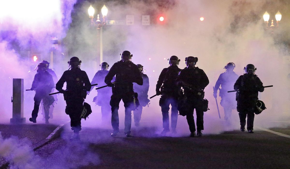 Portland police use riot-control munitions, arrest 8 rock
throwing protesters 1