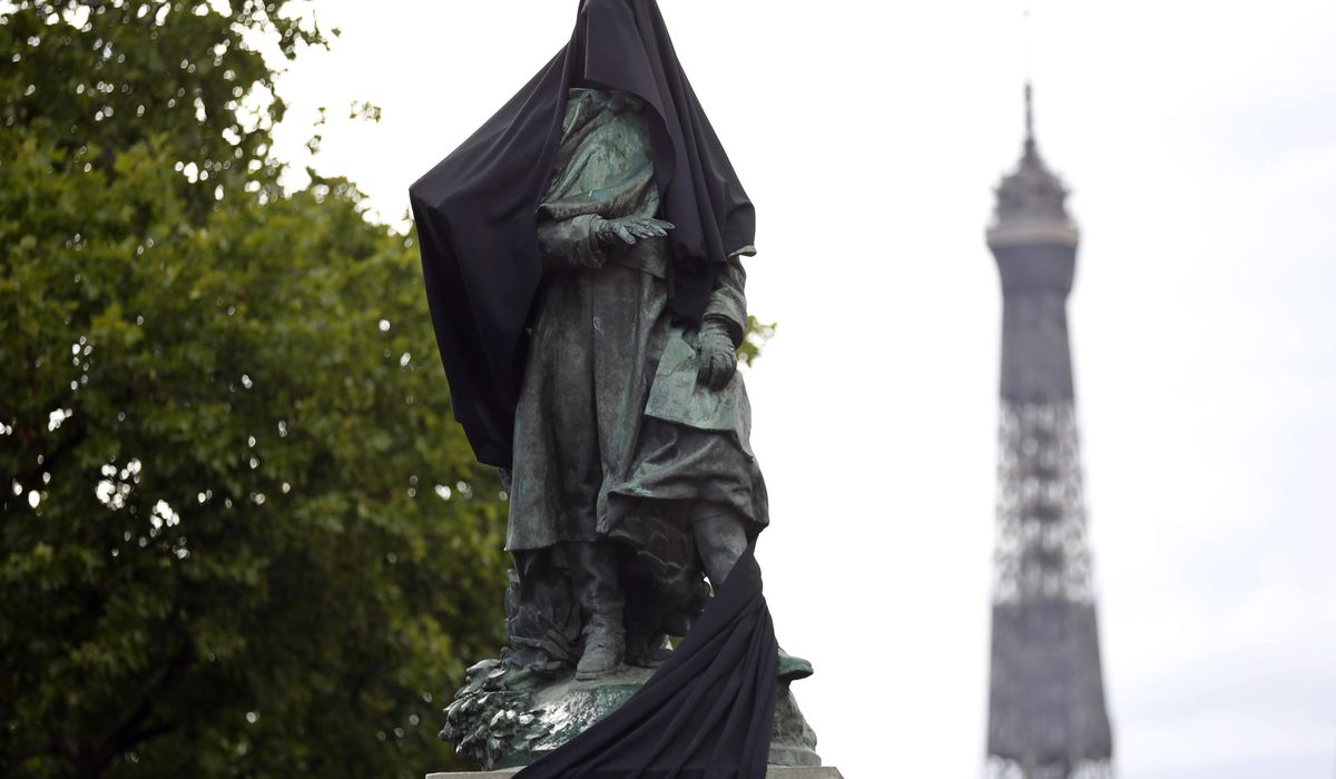 Paris protesters cloak colonial-era statue with black
cloth 1