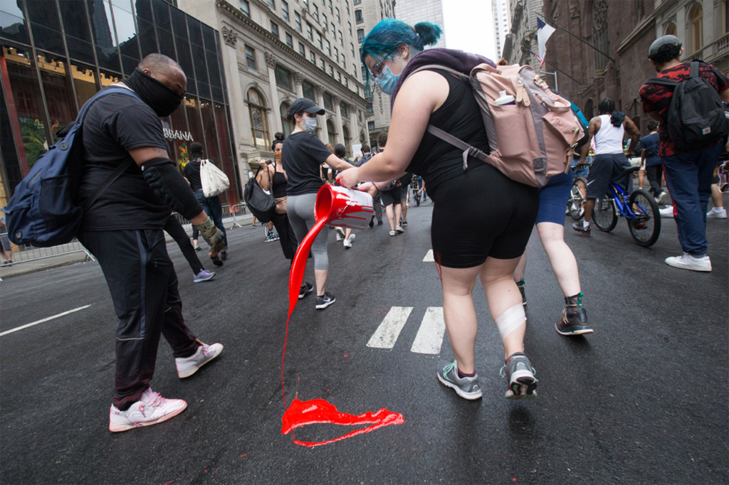Protesters leave trail of paint down 5th Ave. in ‘Blood on
the Street’ march 1