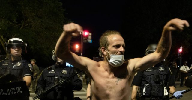 Watch -- Angry D.C. Protesters Scream at Officers: 'I’ll
Hire You to Hold my D*ck' 1