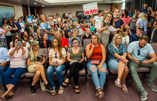 Meeting on masks in Utah schools postponed after crowd
without masks fills the room 1