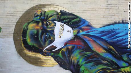 Black mural artists are adding face masks to their street
art in a grassroots PSA to fight coronavirus 1