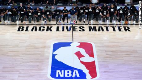 NBA players took a knee before kicking off the reopened
season 1