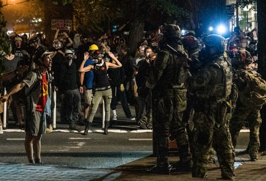 Portland mayor warns 'somebody's going to die' as
protesters, feds face off in another night of violence 1