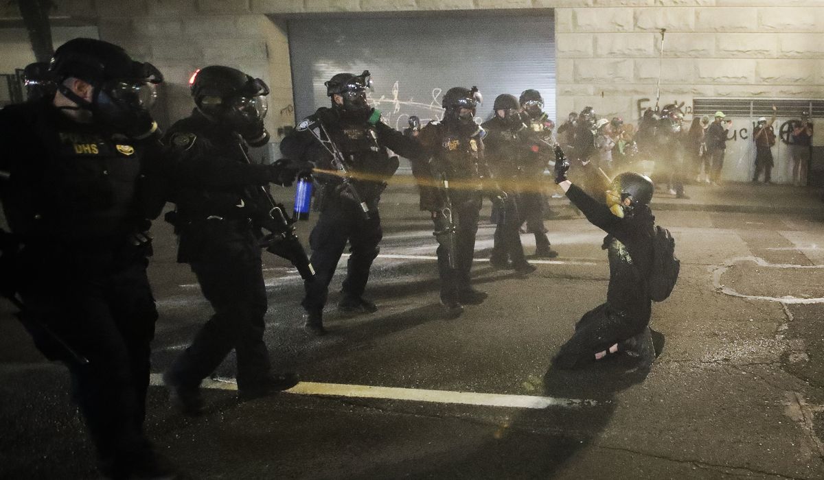 Portland clears protesters from park as part of deal to get
feds to leave 1
