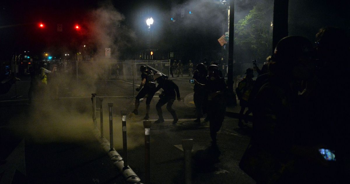 Portland Police Precinct Flooded By Protesters Who Want the
Building Razed 1
