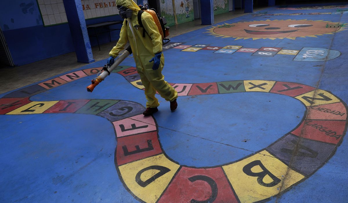 The Latest: India reports another record coronavirus
surge 1