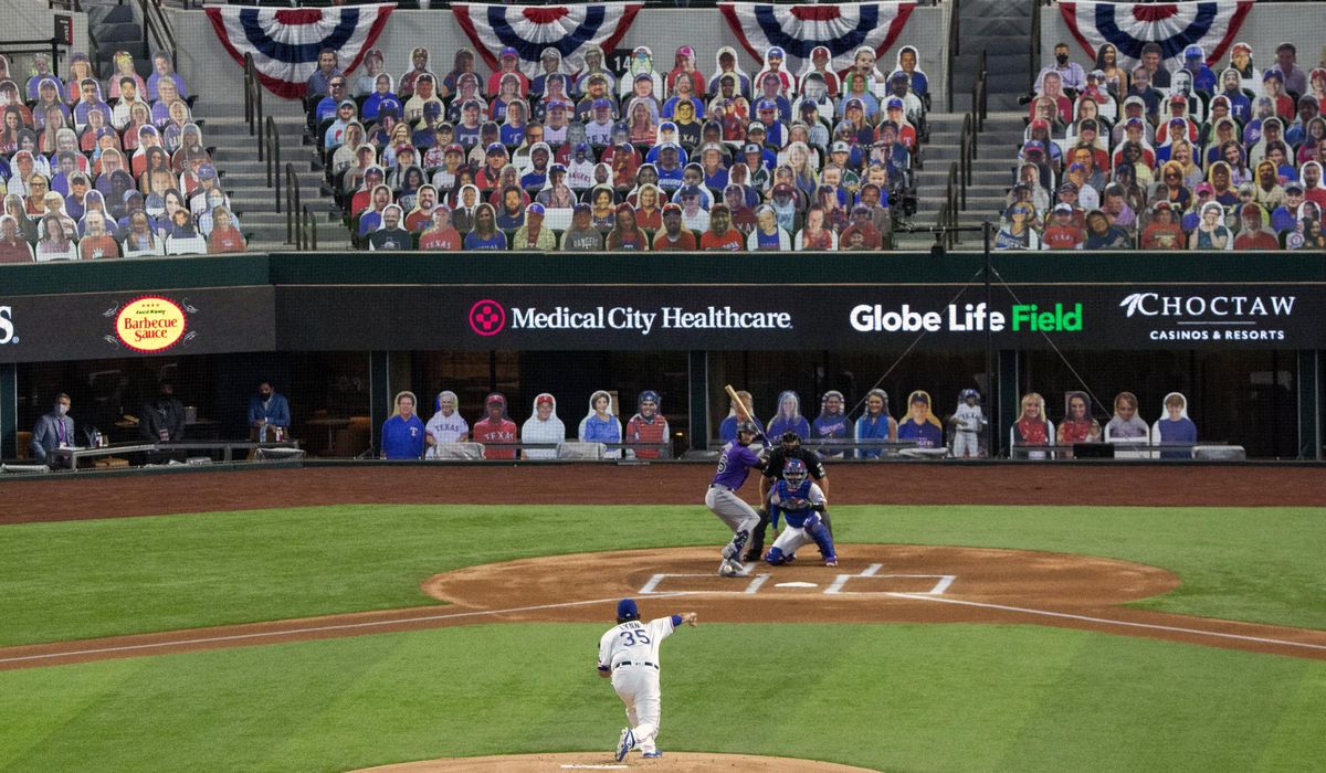 AP PHOTOS: Empty stands, masked players as baseball
returns 1