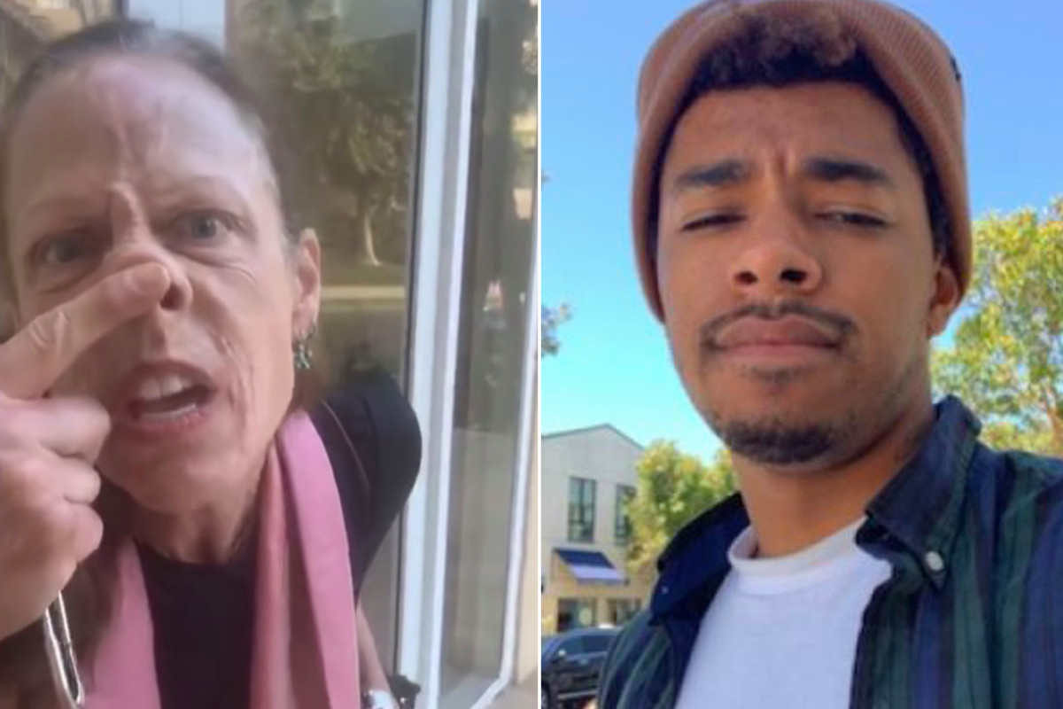 White woman blocks black deliveryman wearing mask from
building 1