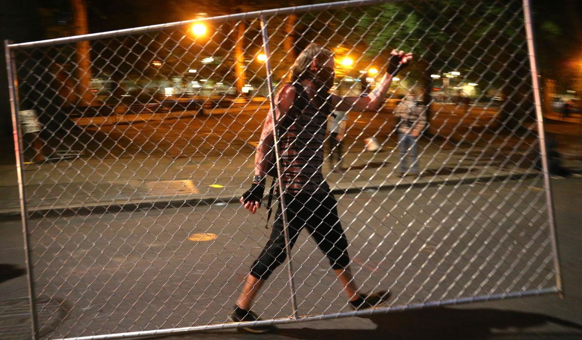 Fires set, fences moved: Police call Portland protest a
riot 1