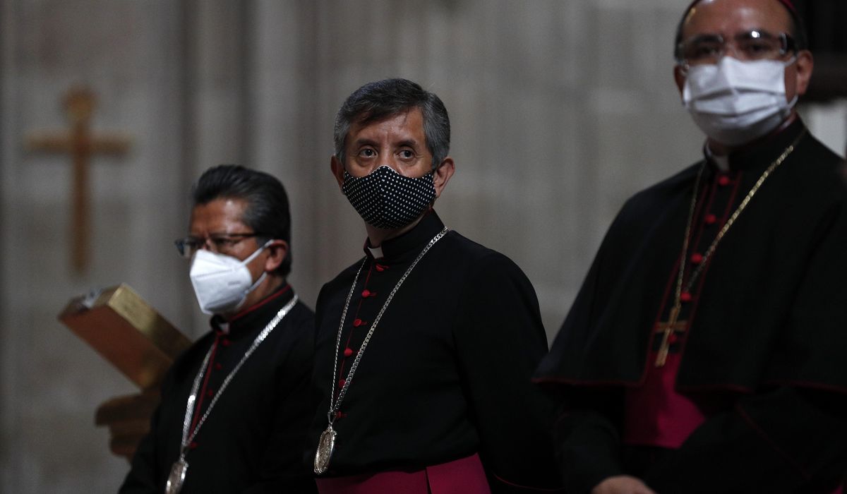 Faithful return to Mexico City churches with masks,
gel 1
