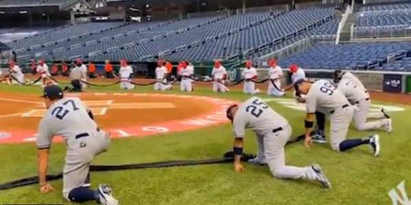 All Yankees and Nationals players and coaches take a knee
before national anthem opening night 1