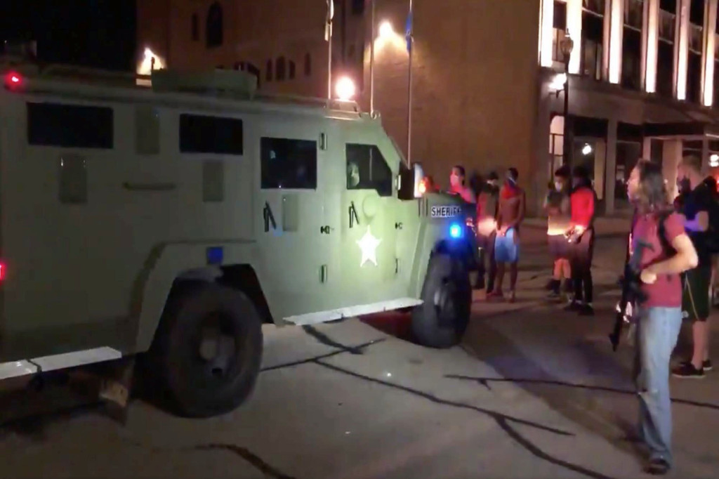 Heavily armed protesters square off with armored police
truck in Kenosha 1