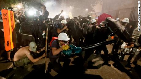 Hundreds of demonstrators march in Portland on 66th night of
protests 1