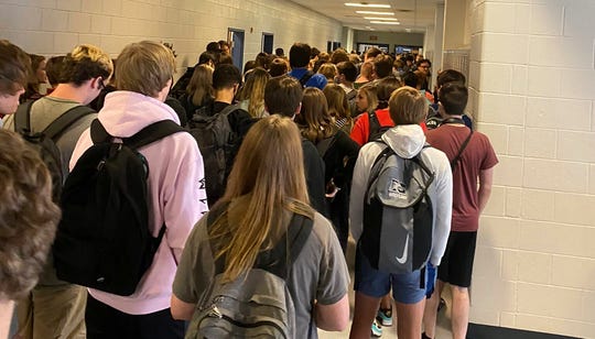 Georgia school lifts suspension for student who shared photo
of crowded hallway, maskless peers 1