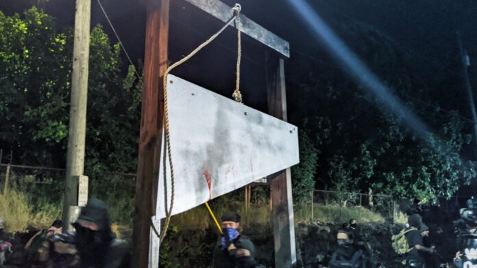 Portland Rioters Bring Guillotine, Burn American
Flags 1