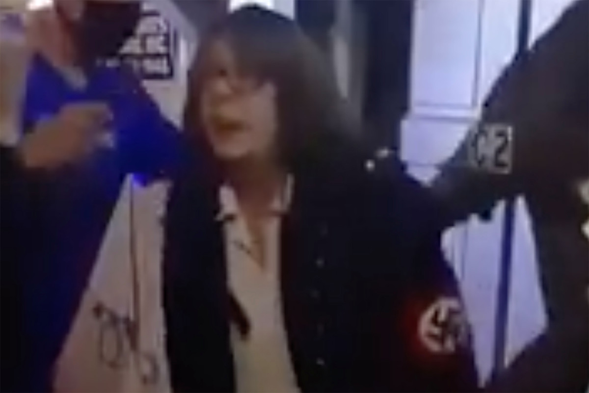 Portland protesters confront woman wearing swastika outside
her house 1