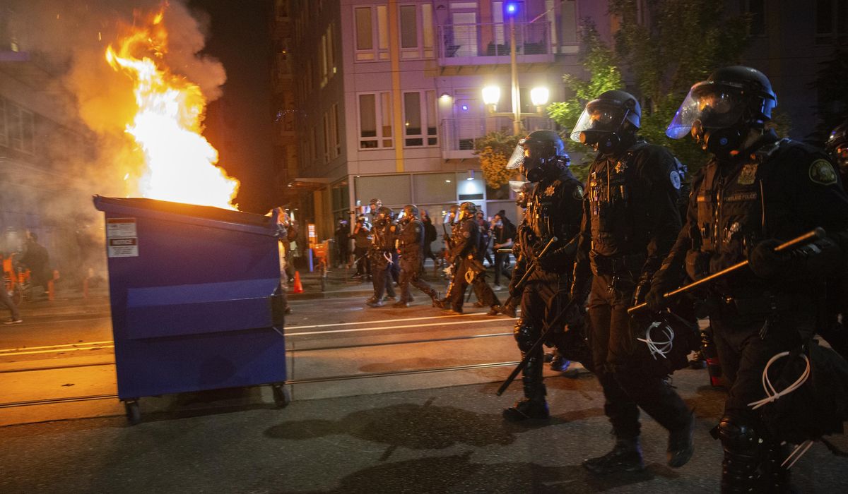 Smoke fills air as Portland police clear riot at
precinct 1