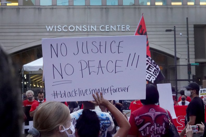Video Appears to Show Wisconsin Protesters Throwing Brick at
Police Officer, Smashing Police Car Windows 1