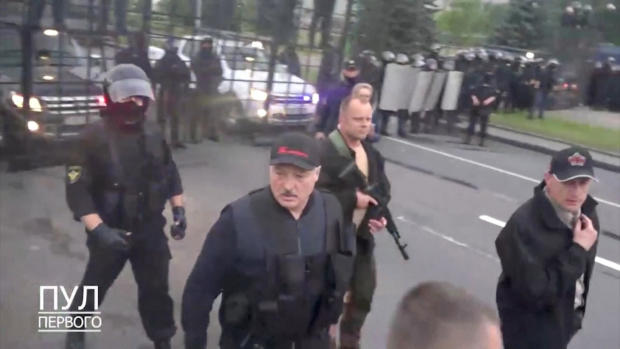 Armed Belarus president defiant as protesters demand
resignation 1