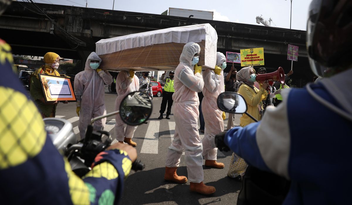 The Latest: India reports another record coronavirus
surge 1
