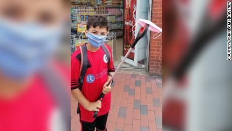 These brothers are picking up littered face masks around
their neighborhood 1