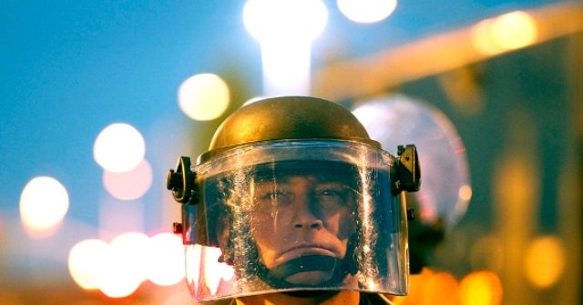 WATCH: Seattle Rioters Hit Cop in the Head with Bat After
He's Knocked Down 1