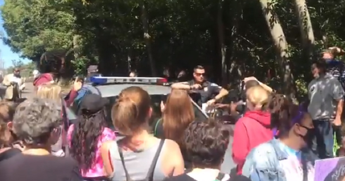 Protesters Retaliate After Arrest Near McConnell’s Home,
Storm Nearby Business 1
