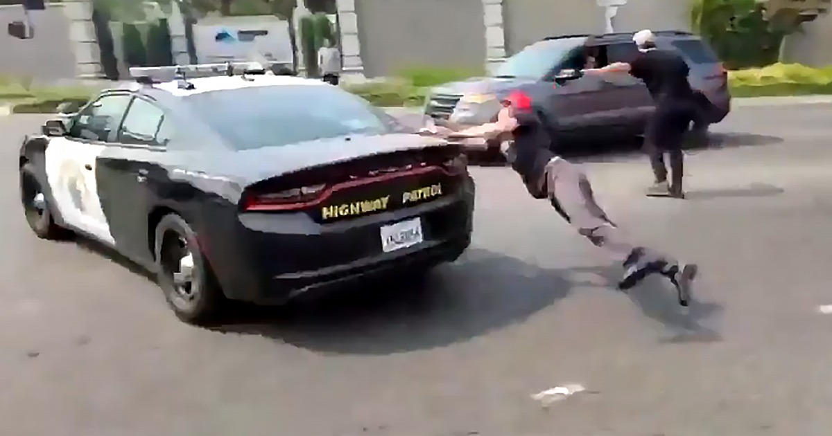 VIDEO: Anti-Trump Protester Jumps On Moving Cop Car, Falls
And Smashes Face On Pavement 1