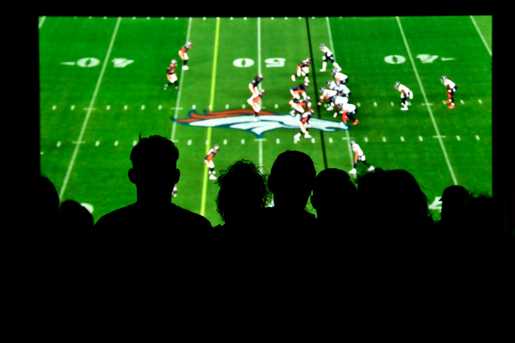 Broncos fans celebrate home opener. From about 12 miles
away. “Got to be there. Got to be.” 1