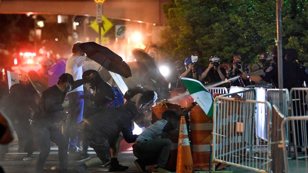 7 officers suspended in Black man's death; protesters
unswayed 1
