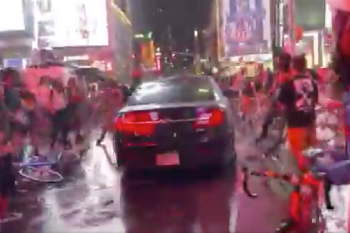 Driver speeds through protesters marching in Times
Square 1