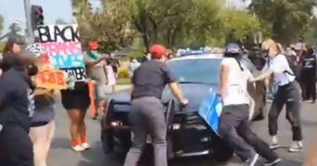 Watch: Police Cruiser Accelerates After Anti-Trump, BLM
Protesters Swarm, One Injured 1
