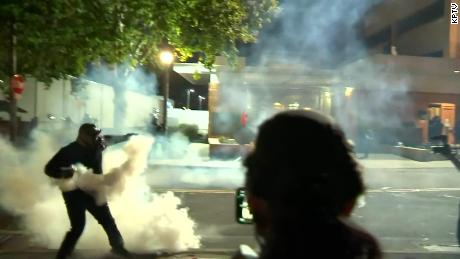 Officers deploy crowd control agents at protesters outside
an ICE building in Portland 1