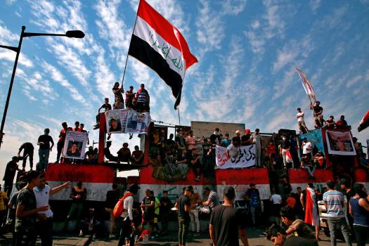 Tear gas fired as thousands mark one year of Iraq
protests 1