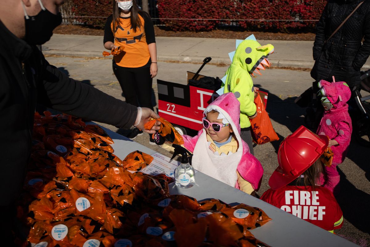 Candy chutes and drive-thru treats: Chicagoans get creative
for COVID-19 Halloween 1