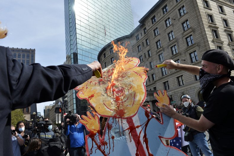 Donald Trump Cutout Set on Fire, Two Arrested During Dueling
Boston Protests 1