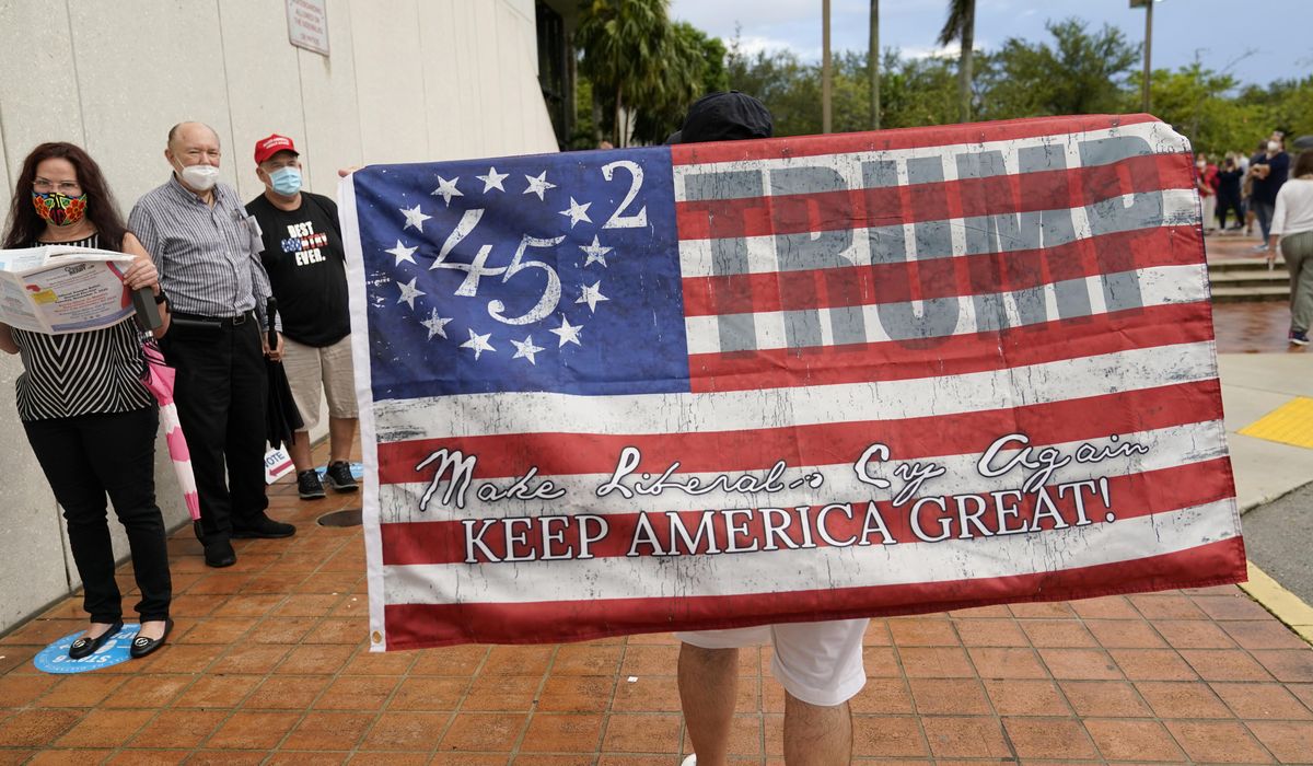 Miami police officer faces suspension for wearing Trump mask
at voting site 1