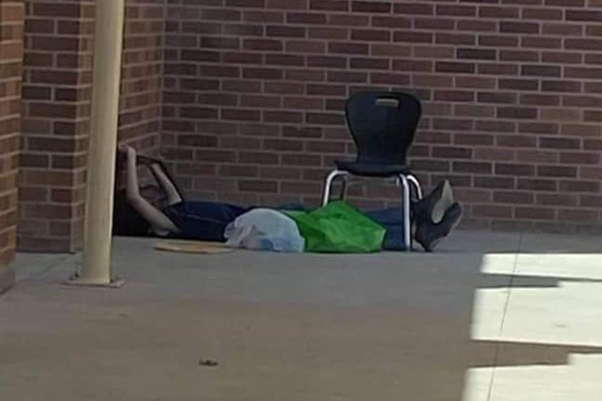 9-year-old boy sits outside empty school to remote learn
amid COVID-19 1