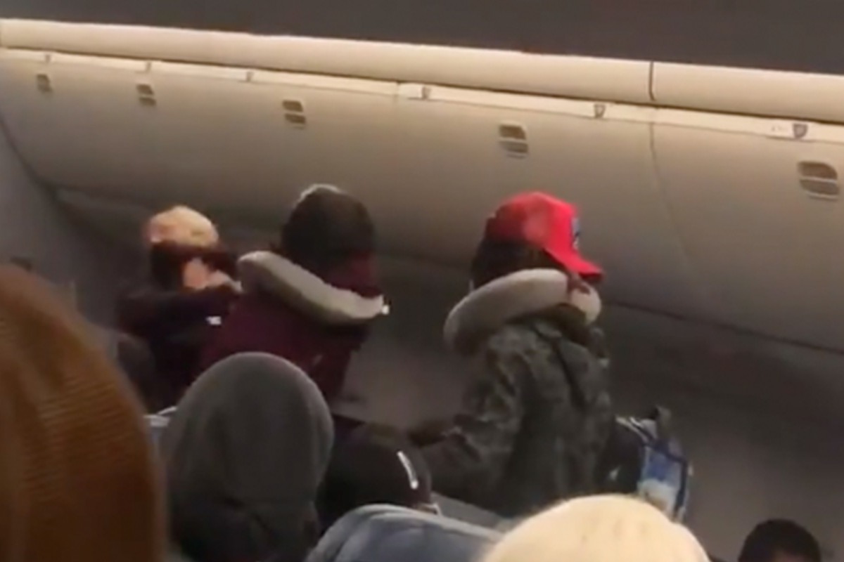 Video shows woman punch flight attendant while wearing mask
incorrectly 1