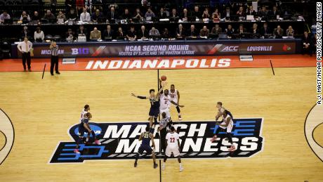 College basketball season tips off during coronavirus surge,
with March Madness the ultimate goal 1