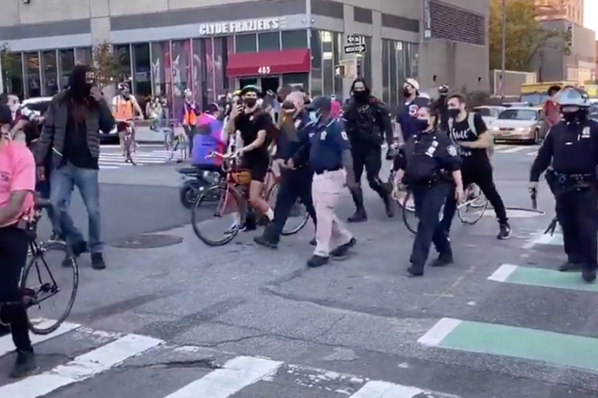 Woman knocks camera from detective’s hand during anti-cop
protest 1